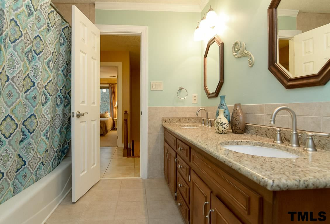8101 Winstone Court Raleigh, NC 27615 - Photo 16 of 25 Updated hall bath with granite counters and tile surround. Bathroom