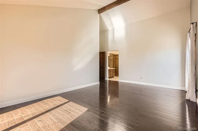 a view of an empty room and wooden floor