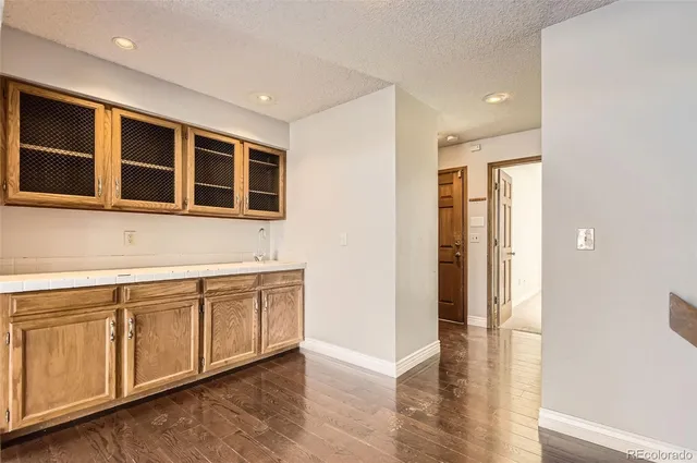 a view of a kitchen with stainless steel appliances granite countertop a refrigerator and a sink