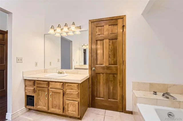 a bathroom with a sink vanity and a mirror