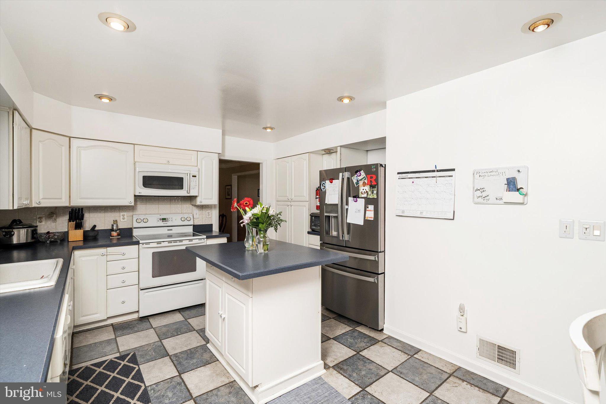 3 David Drive Ewing, NJ 08638 - Photo 9 of 32 a kitchen with stainless steel appliances a stove top oven a sink a counter top space and cabinets