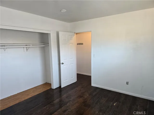 a view of a room with wooden floor and closet
