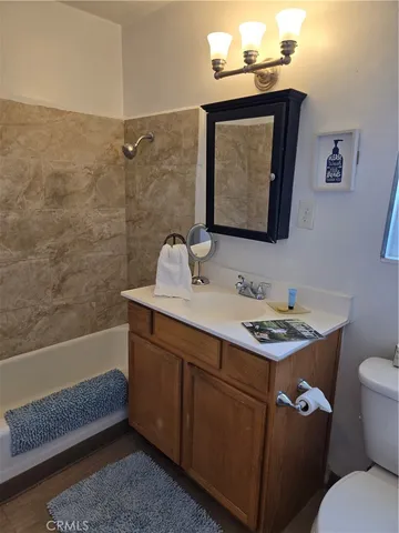 a bathroom with a shower curtain and a toilet
