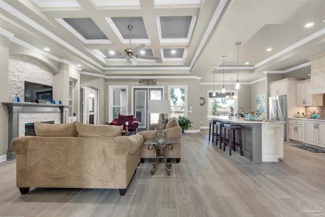 a living room with furniture and a view of kitchen