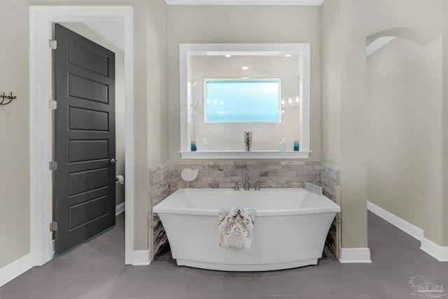 a bathroom with a granite countertop sink a toilet a mirror and shower