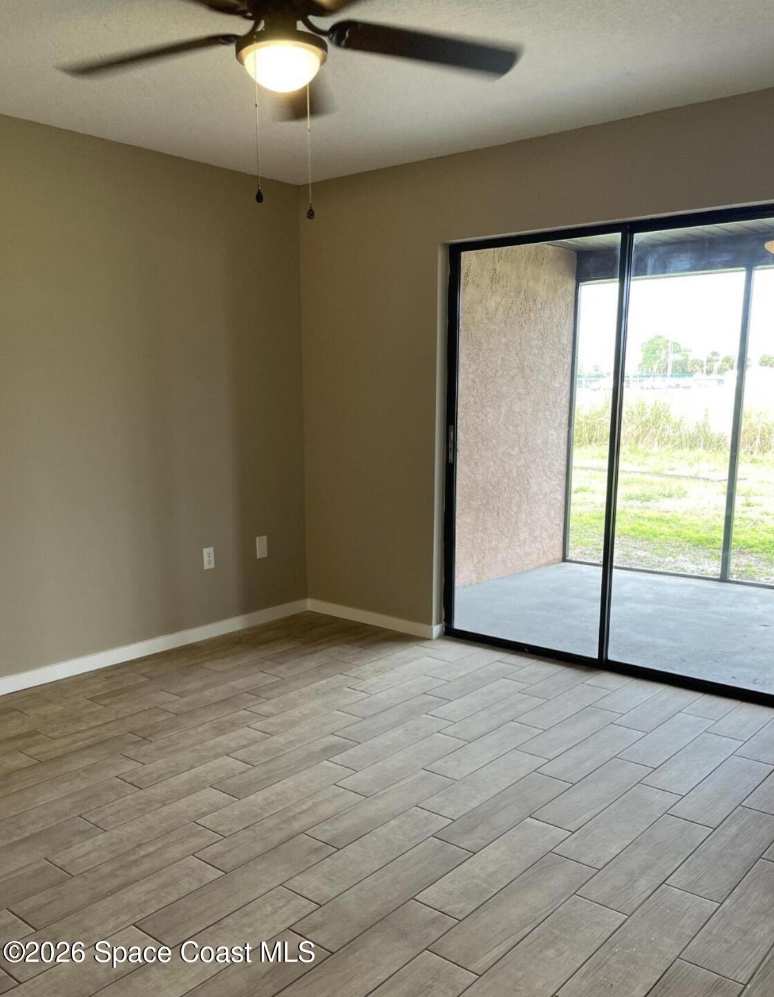 830 Angela Avenue, Unit B Rockledge, FL 32955 - Photo 5 of 9 a view of an empty room with a window