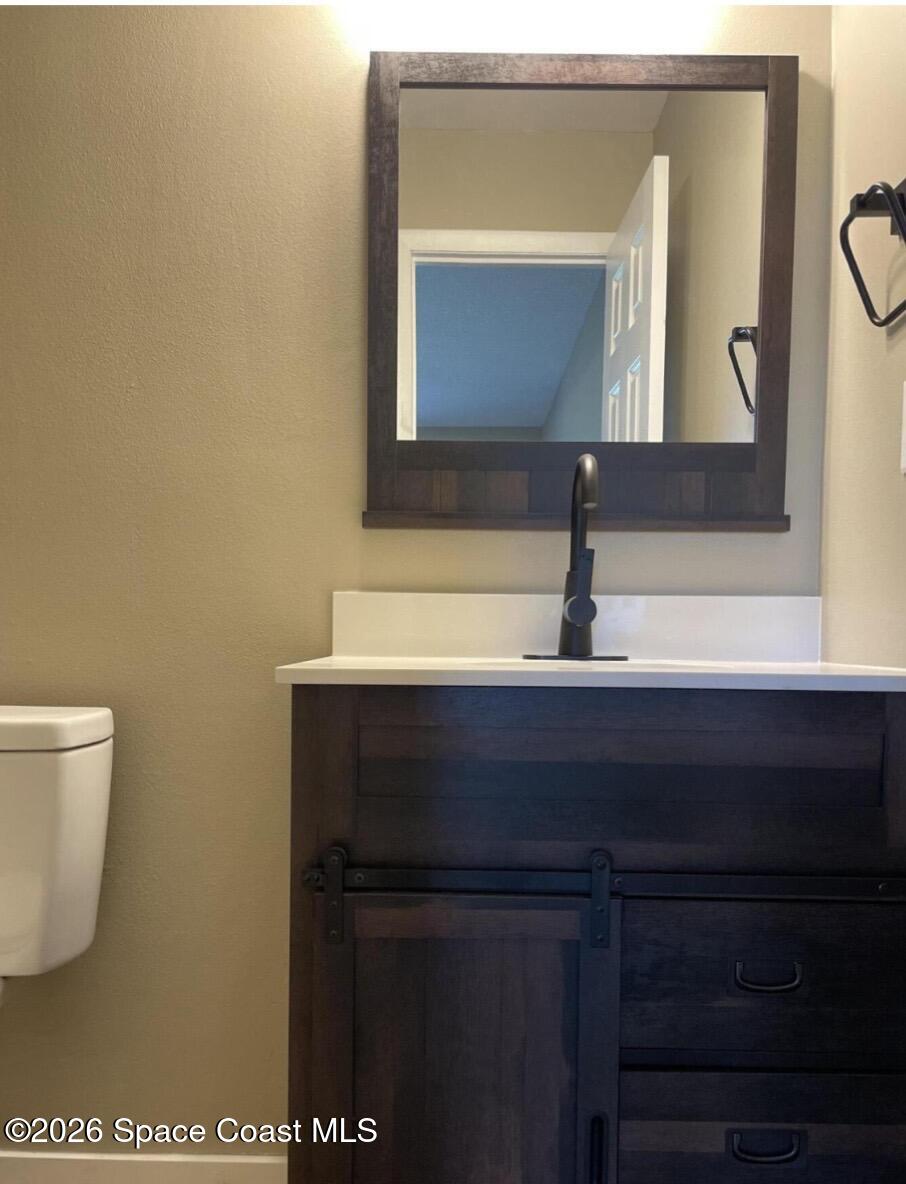 830 Angela Avenue, Unit B Rockledge, FL 32955 - Photo 7 of 9 a bathroom with a sink and a mirror