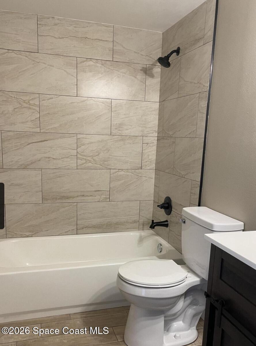 830 Angela Avenue, Unit B Rockledge, FL 32955 - Photo 8 of 9 a bathroom with a toilet and a bath tub
