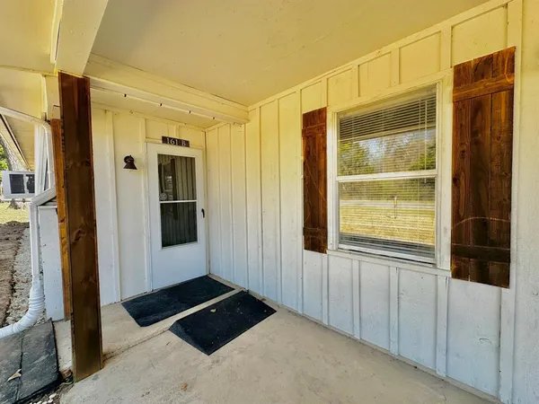 a bathroom with a shower and a window