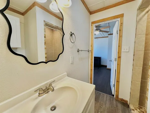 a bathroom with a tub sink and mirror