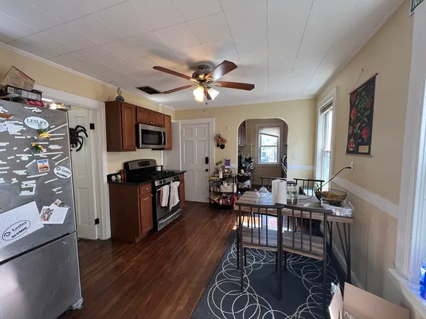a view of a livingroom with furniture a flat screen tv and a stove