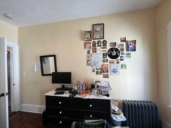 a view of a workspace with furniture and wooden floor