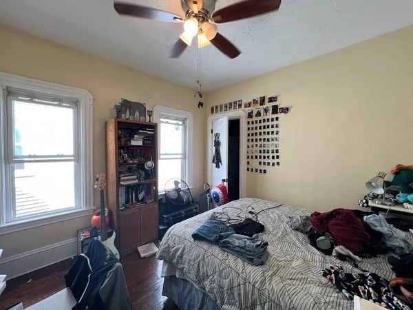 a bedroom that has a bed and a chandelier