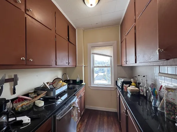 a kitchen with a stove a sink and cabinets