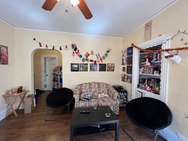 a living room with furniture and wooden floor