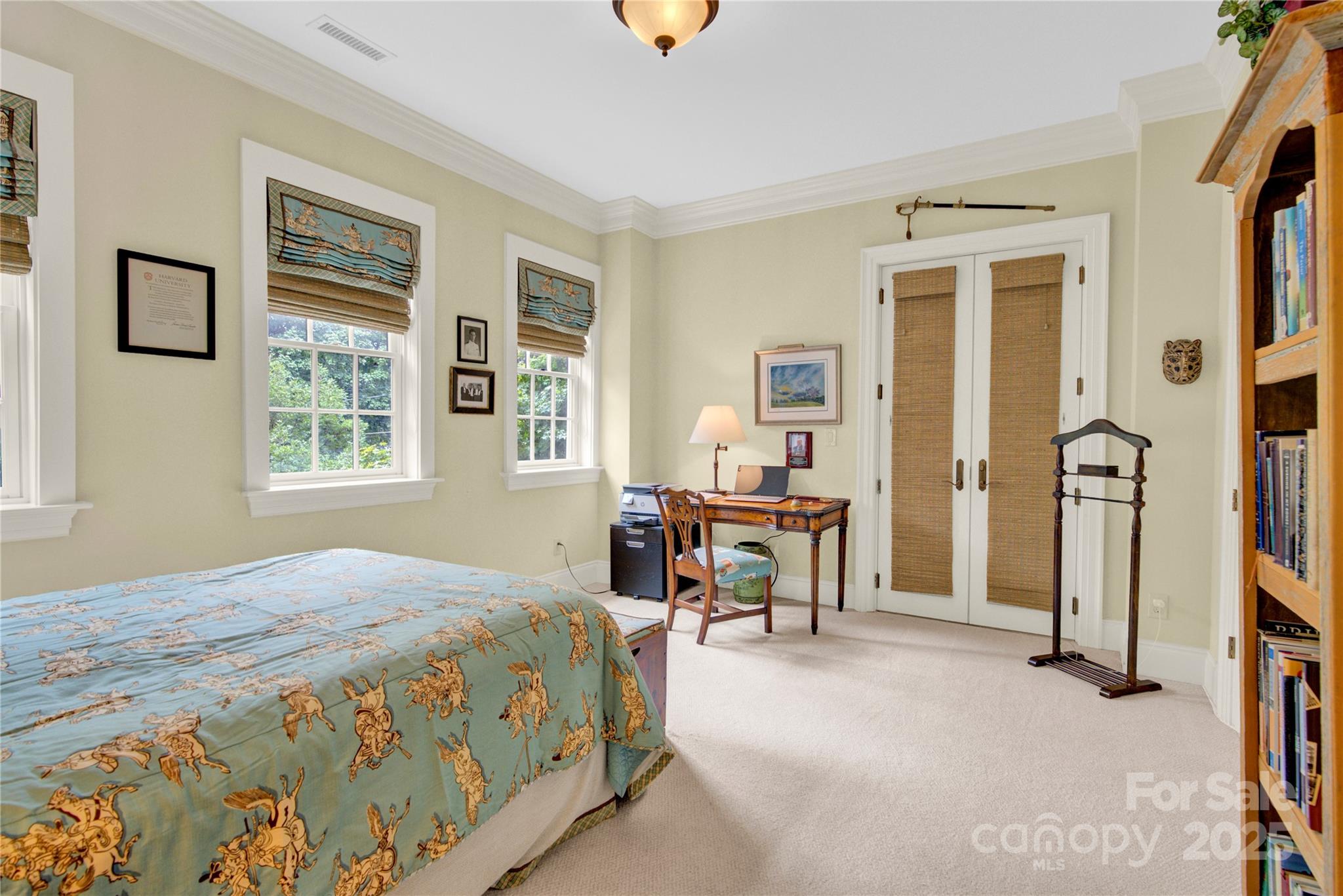 164 Cherokee Road Charlotte, NC 28207 - Photo 23 of 32 a bedroom with a bed next to a window and a flat tv screen