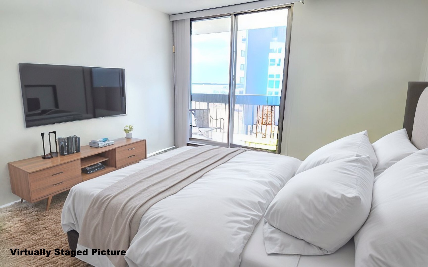 5901 North Sheridan Road, Unit 16C Chicago, IL 60660 - Photo 12 of 28 a bedroom with a bed and a flat screen tv