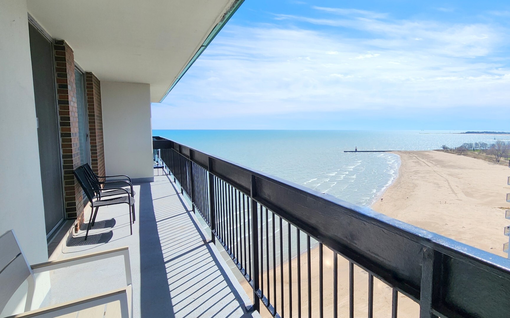5901 North Sheridan Road, Unit 16C Chicago, IL 60660 - Photo 15 of 28 a view of balcony with wooden floor and stairs