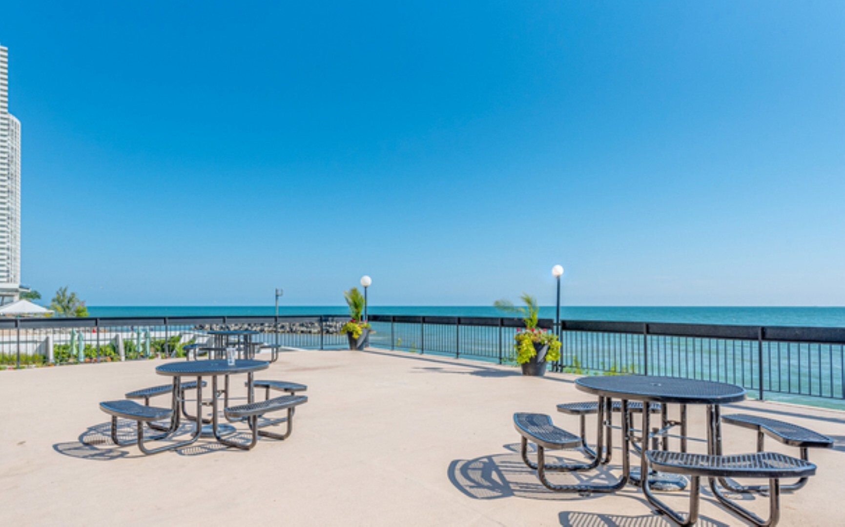 5901 North Sheridan Road, Unit 16C Chicago, IL 60660 - Photo 19 of 28 a view of a chairs and table on the terrace