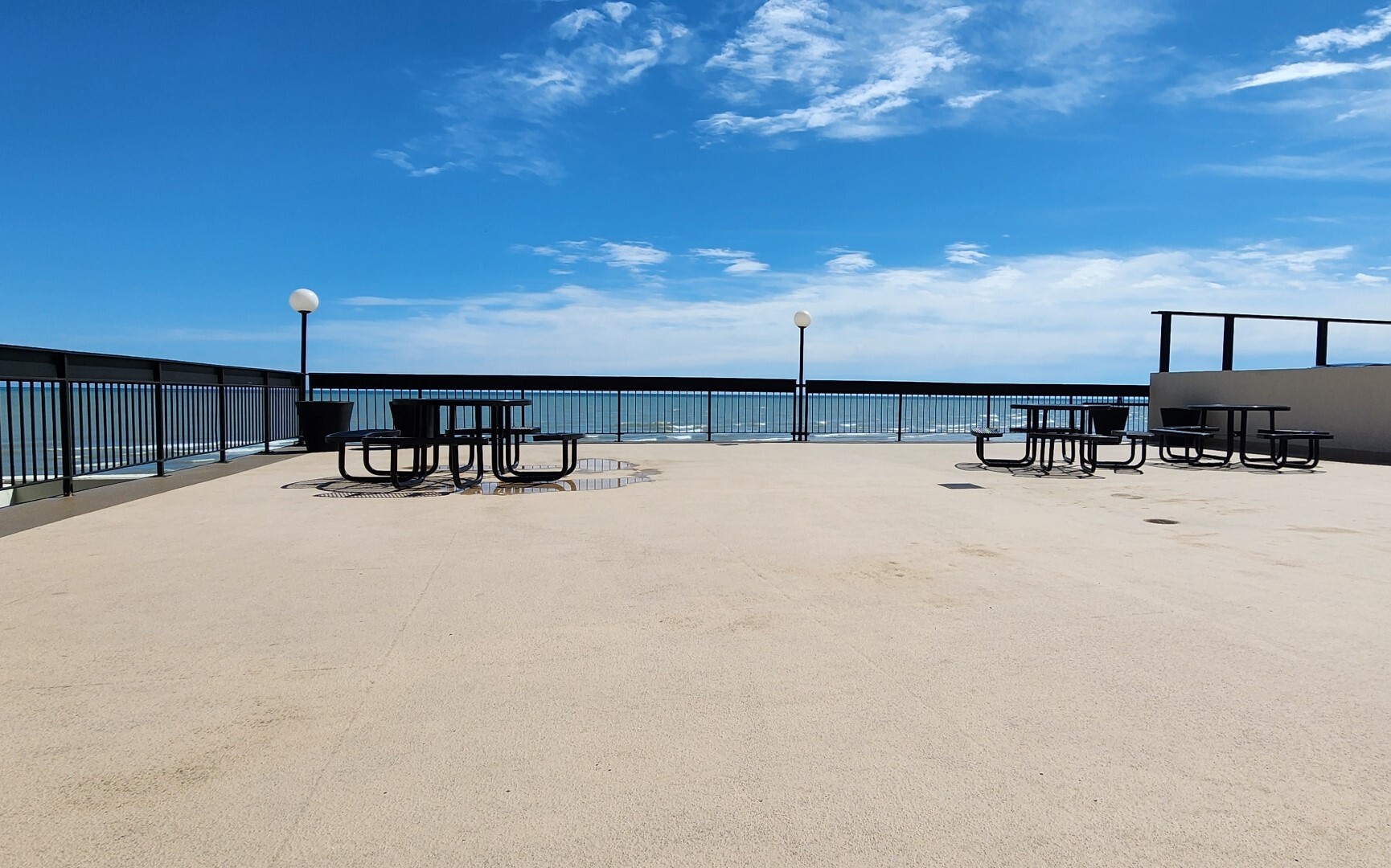 5901 North Sheridan Road, Unit 16C Chicago, IL 60660 - Photo 20 of 28 a view of a terrace with a bench