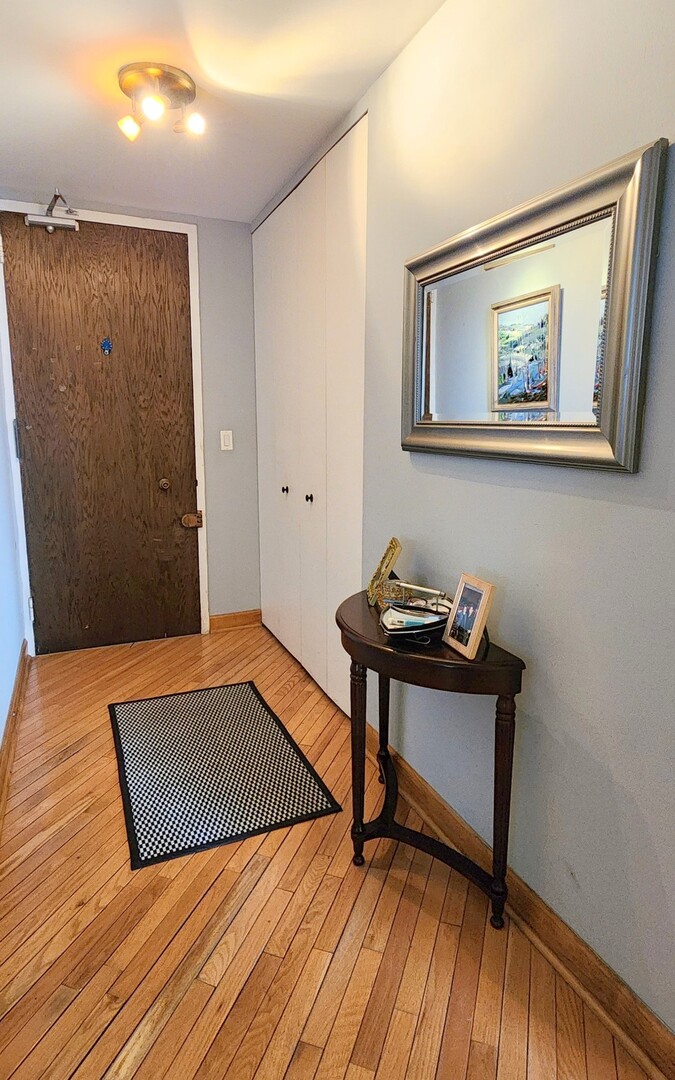 5901 North Sheridan Road, Unit 16C Chicago, IL 60660 - Photo 4 of 28 a view of a room with wooden floor and small workspace