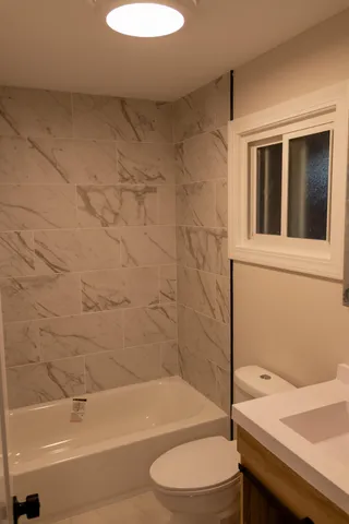 a bathroom with a sink a toilet and a bathtub