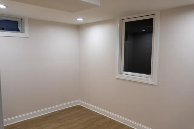 an empty room with wooden floor and closet