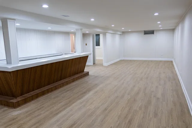 a view of an empty room with wooden floor