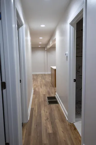 a view of a hallway with wooden floor