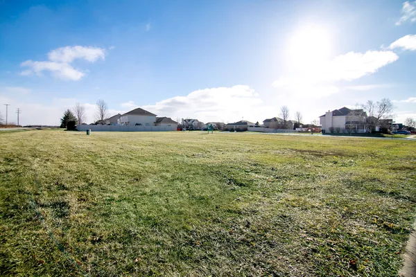 a view of a big yard with an buildings in the background
