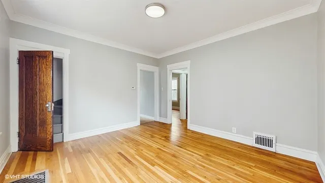 a view of a livingroom with wooden floor and door
