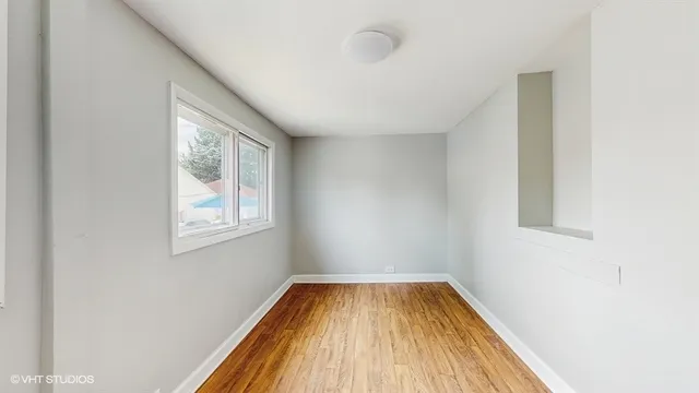a view of a room with wooden floor and window