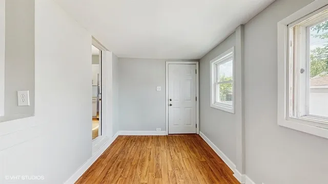 a view of a room with wooden floor and window