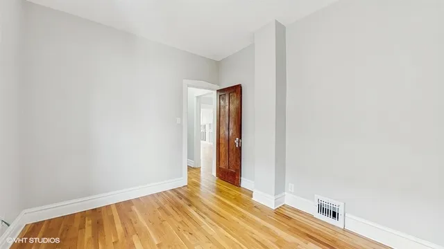 a view of a room with wooden floor and bathroom