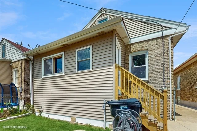 a view of a house with wooden fence