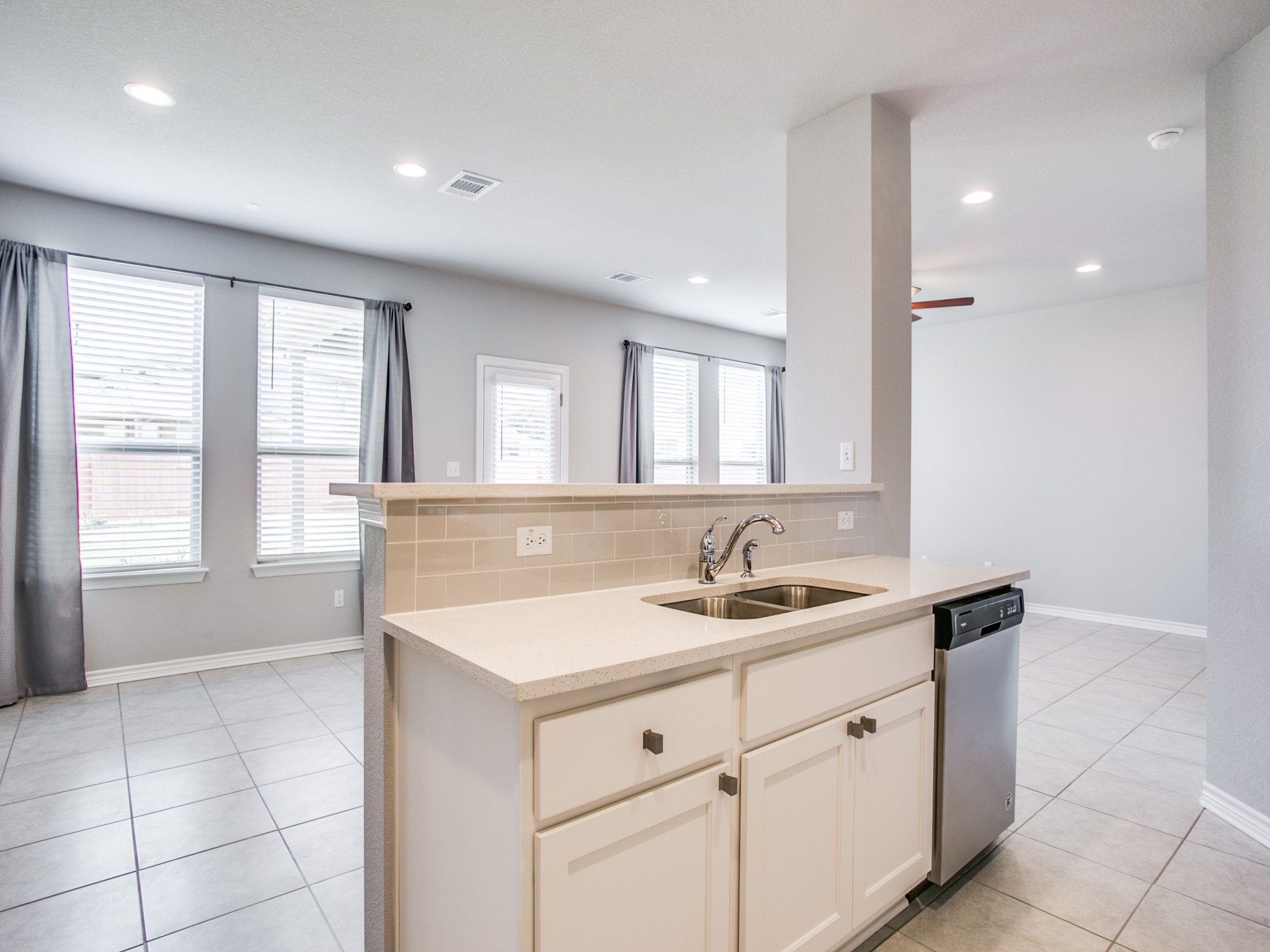508 Rearing Mare Pass Georgetown, TX 78626 - Photo 5 of 26 Kitchen featuring a sink, stainless steel dishwasher, decorative backsplash, white cabinets, solid countertops, and light tile patterned floors