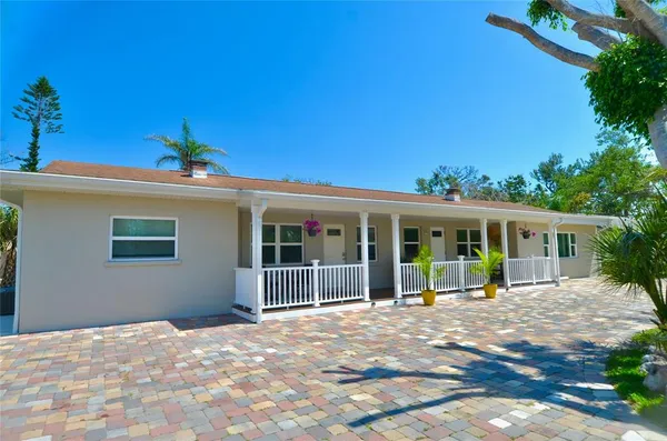 a view of a house with a backyard
