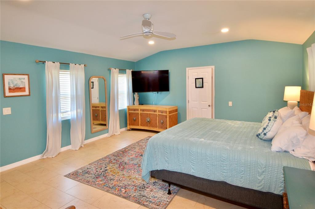 411 Pameto Road Nokomis, FL 34275 - Photo 22 of 85 a bedroom with a bed and flat screen tv
