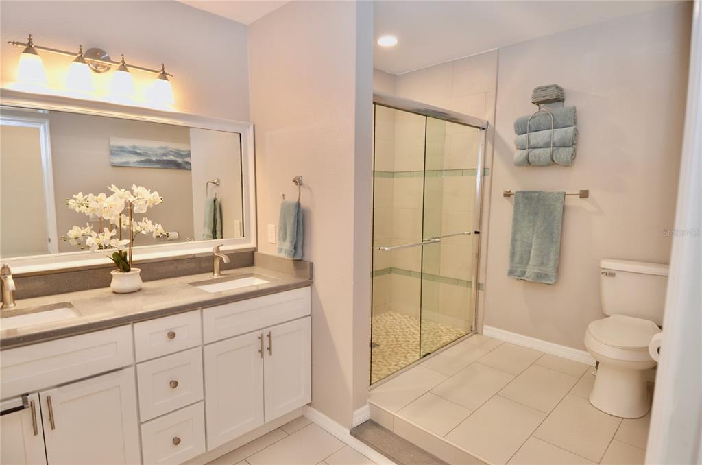 411 Pameto Road Nokomis, FL 34275 - Photo 23 of 85 a bathroom with a granite countertop sink a toilet a mirror and shower