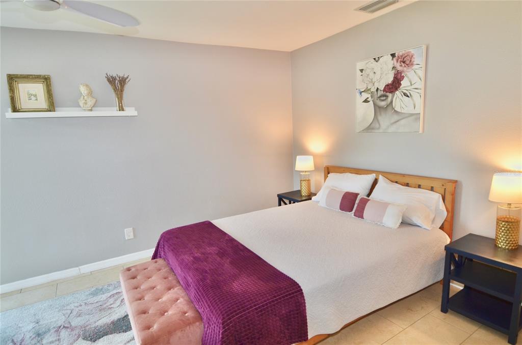 411 Pameto Road Nokomis, FL 34275 - Photo 26 of 85 a bedroom with a bed and a painting on the wall