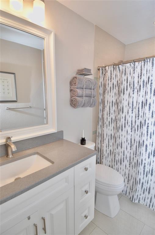 411 Pameto Road Nokomis, FL 34275 - Photo 28 of 85 a bathroom with a sink a toilet and vanity