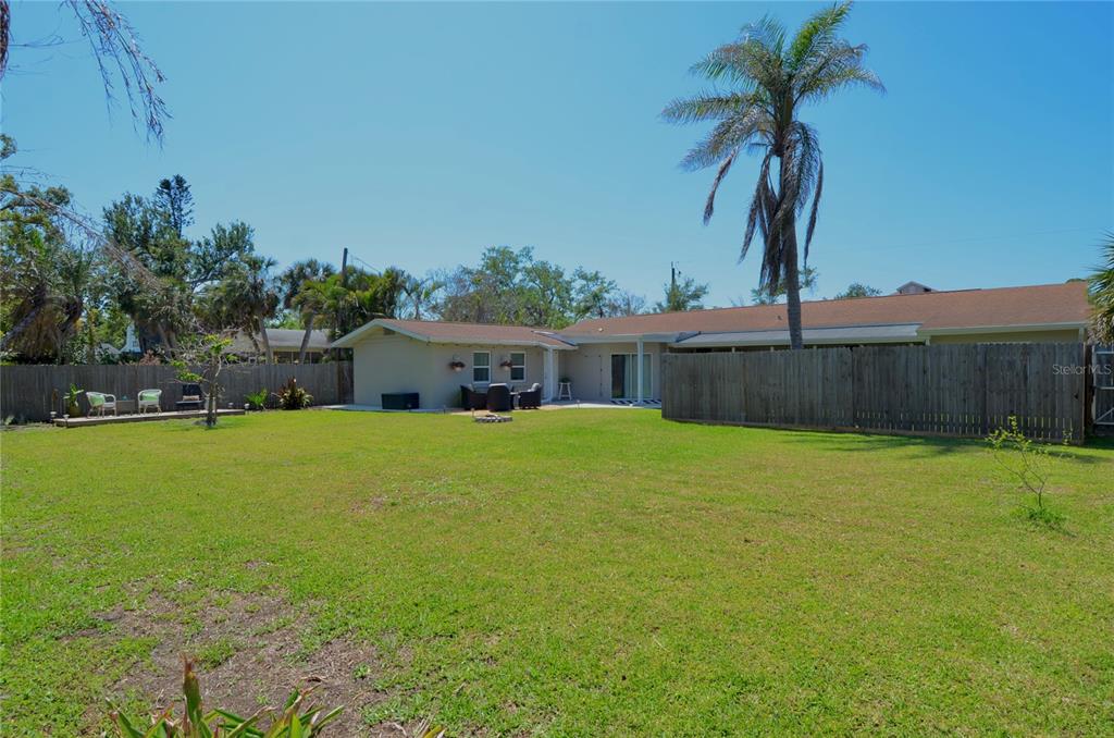 411 Pameto Road Nokomis, FL 34275 - Photo 32 of 85 a front view of a house with a yard and a garden
