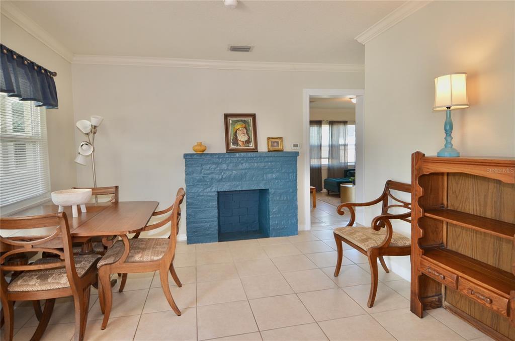 411 Pameto Road Nokomis, FL 34275 - Photo 40 of 85 a living room with furniture a fireplace and a flat screen tv