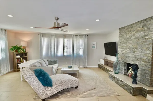 a living room with fireplace furniture and a flat screen tv