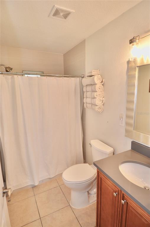 411 Pameto Road Nokomis, FL 34275 - Photo 44 of 85 a white toilet sitting next to a bathroom sink