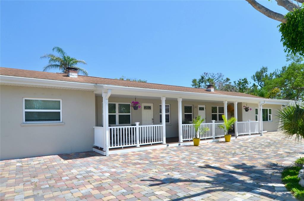411 Pameto Road Nokomis, FL 34275 - Photo 58 of 85 a view of a house with a backyard and a porch