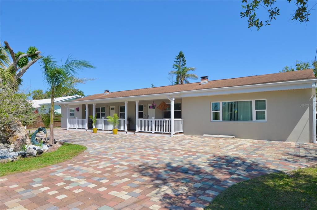 411 Pameto Road Nokomis, FL 34275 - Photo 67 of 85 a front view of a house with a garden and yard