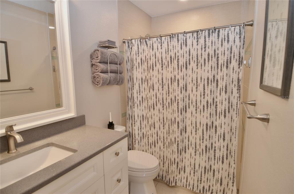 411 Pameto Road Nokomis, FL 34275 - Photo 9 of 85 a bathroom with a granite countertop sink toilet and mirror