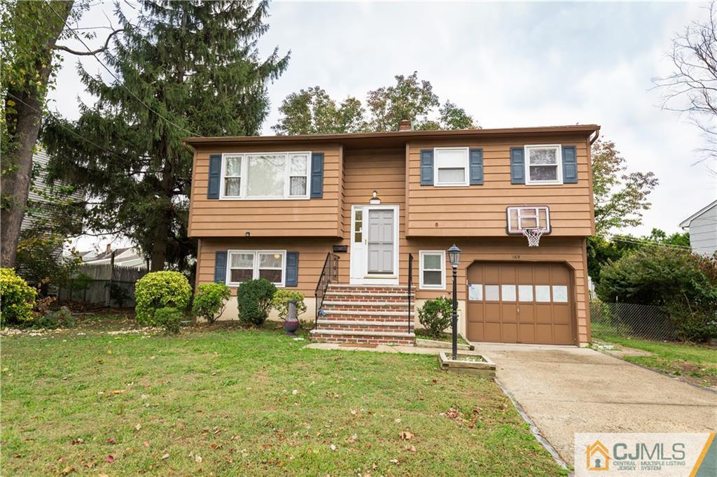 169 Old Post Road Edison, NJ 08817 - Photo 1 of 36 a front view of a house with a garden and plants