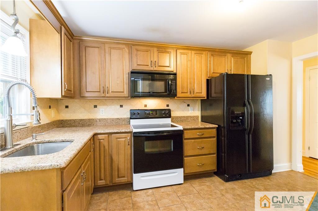 169 Old Post Road Edison, NJ 08817 - Photo 11 of 36 a kitchen with stainless steel appliances granite countertop a refrigerator stove and sink